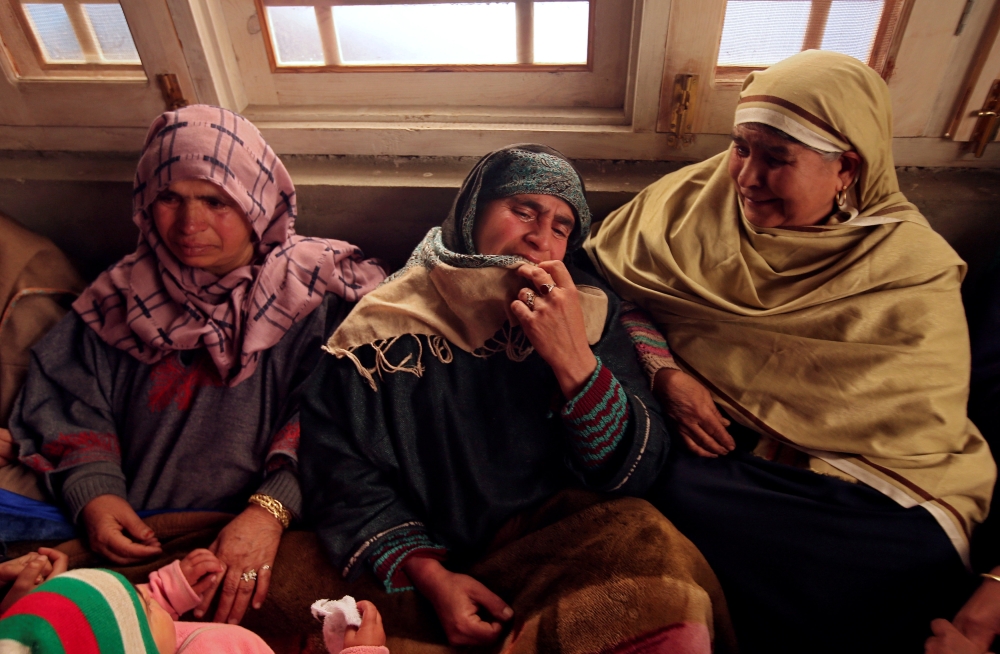Relatives of Adil Ahmad Dar, who according to police carried out the suicide attack on the Central Reserve Police Force (CRPF) convoy and killed 44 of them on Thursday, mourn inside Adil’s residence in Gundbagh village in south Kashmir’s Pulwama district, on Friday. — Reuters