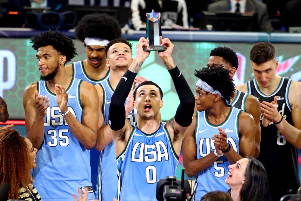 Team USA forward Kyle Kuzma of the Los Angeles Lakers celebrates winning the MVP of the All-Star Rising Stars game at Spectrum Center Friday . — Reuters