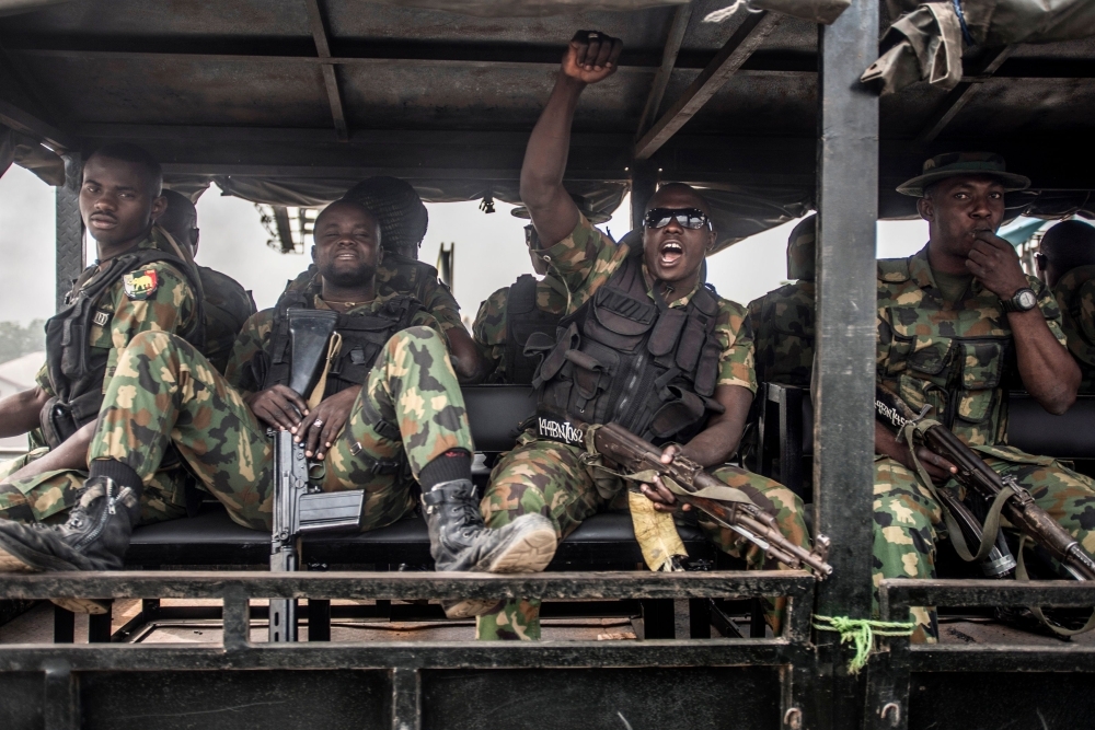 Nigerian soldiers ride in a truck during a patrol of Aba, a city in southern eastern Nigeria and a stronghold for pro-biafran separatists, during a military patrol, Friday. — AFP