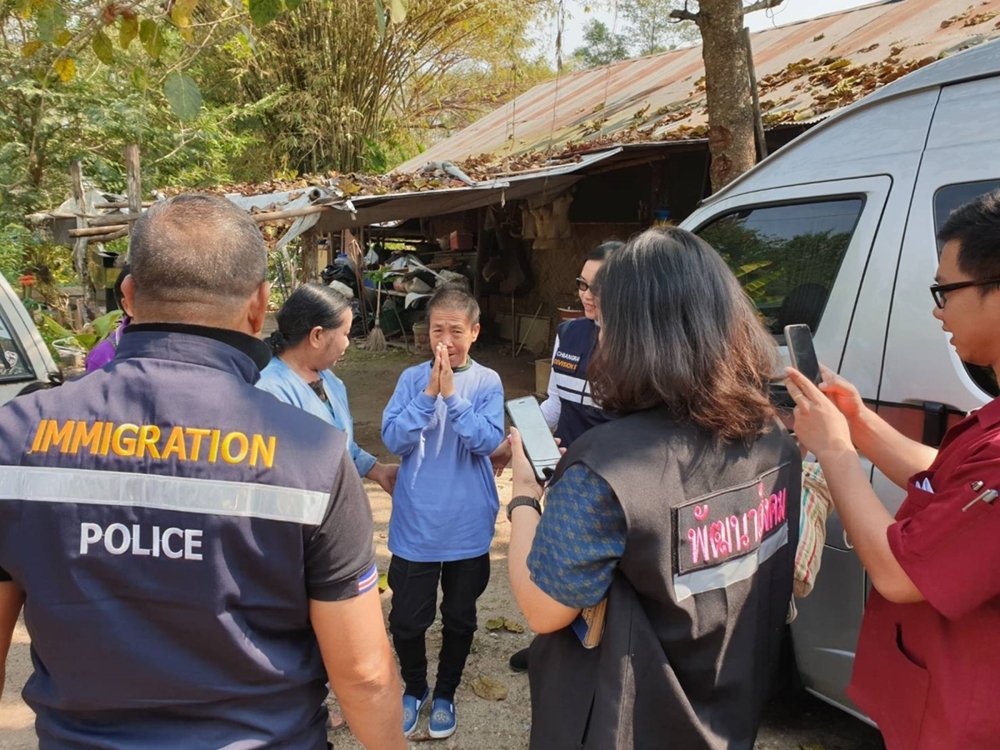 In this handout photo taken and released by the Thai Immigration Police Kaeomanee Arjaw, (C), greets Thai Immigration Police upon arriving home in Chiang Rai.  — AFP