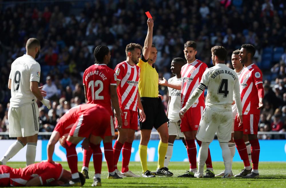 Real Madrid’s Sergio Ramos is shown a red card by referee Guillermo Cuadra during the La Liga Santander match against Girona at Santiago Bernabeu in Madrid Sunday. — Reuters