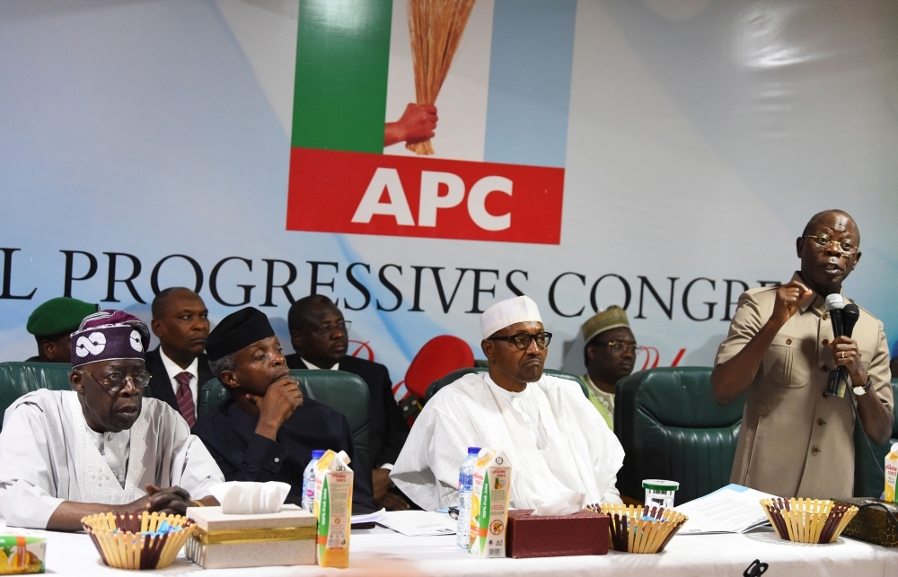 Candidate of the All Progressives Congress (APC) President Mohammadu Buhari, center, sits as party chairman Adams Oshiomhole, right, speaks while party national leader Bola Tinubu, left, and Vice President Yemi Osinbajo, second left, listen, during the party caucus emergency meeting on the postponed general elections in Abuja on Monday. — AFP