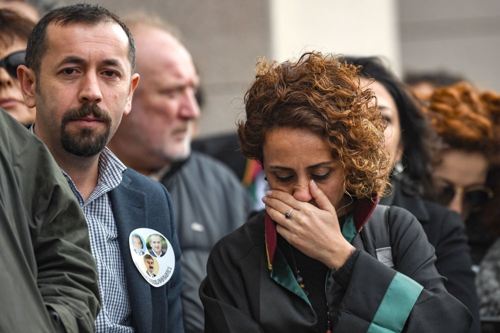 Lawyers and opposition MPs gather outside the Caglayan courthouse in Istanbul to protest against the upholding by an appeal court of the jail sentences against opposition journalists in a long-running case targeting the Cumhuriyet newspaper on Thursday. — AFP