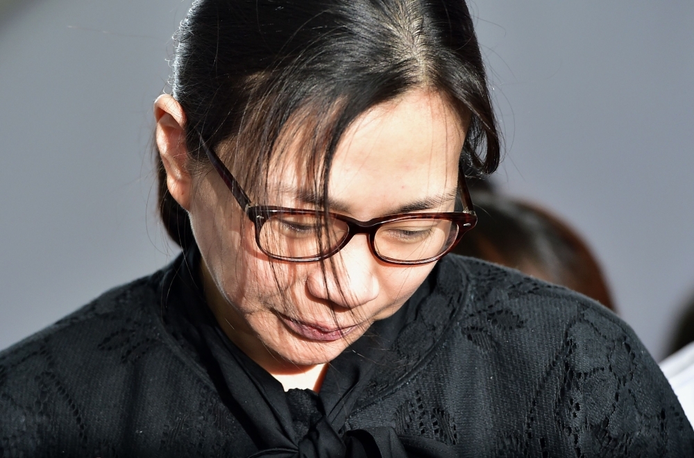 Former Korean Air (KAL) executive Cho Hyun-Ah is surrounded by journalists after receiving a suspended jail sentence at a court in Seoul in this May 22, 2015 file photo. — AFP