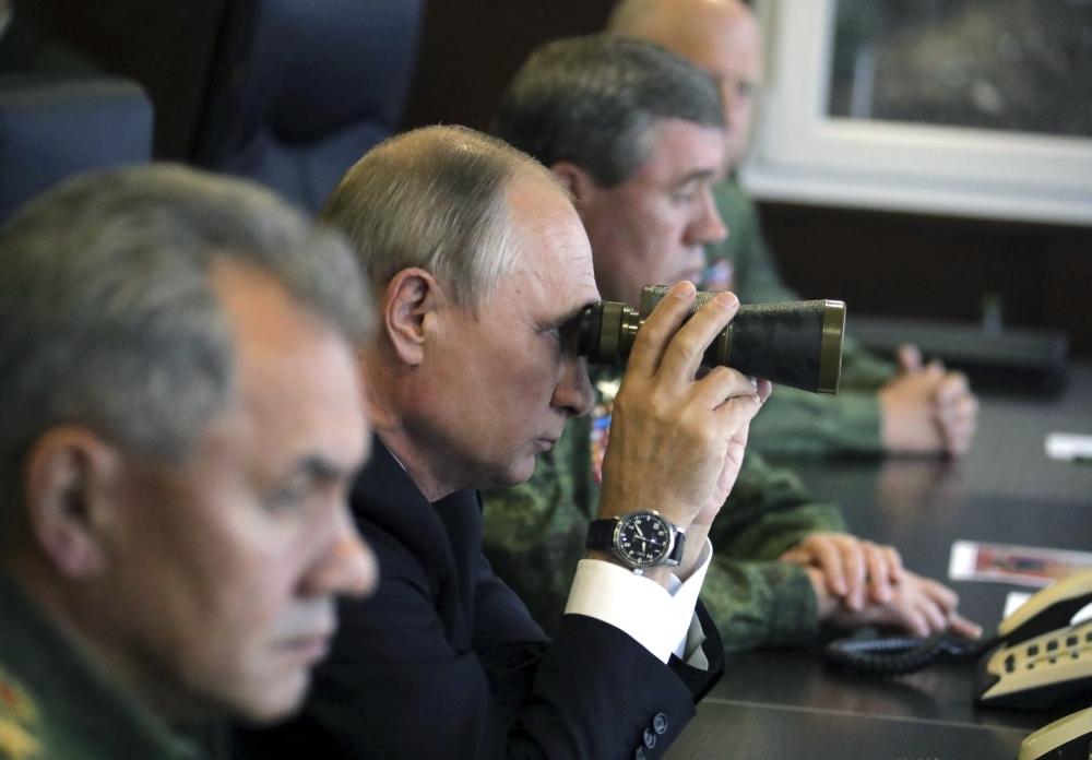 Russian President Vladimir Putin uses a pair of binoculars while watching the Zapad-2017 war games, held by Russian and Belarussian servicemen, at a military training ground in the Leningrad region, Russia, in this Sept. 18, 2017 file photo. — Reuters