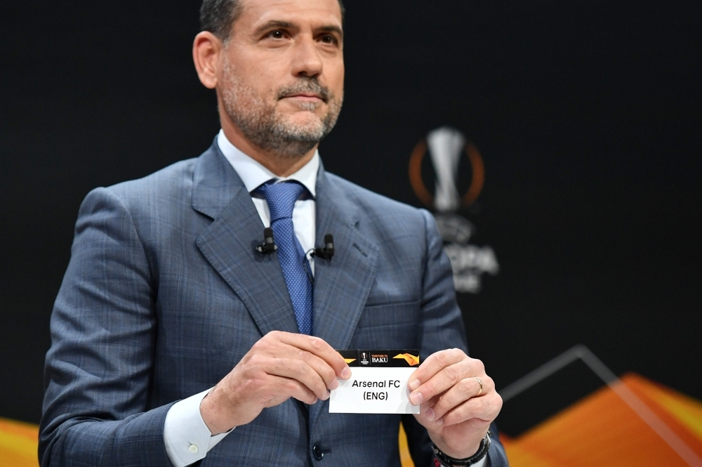 Former Spanish football player Andres Palop displays the name of Arsenal football club during the draw for the Europa League round of sixteen, on Friday in Bern. — AFP