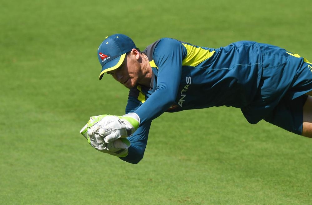 Australian cricketer Peter Handscomb attempts a catch at a training session at the Dr. Y.S. Rajasekhara Reddy ACA–VDCA Cricket Stadium in Visakhapatnam Saturday. — AFP