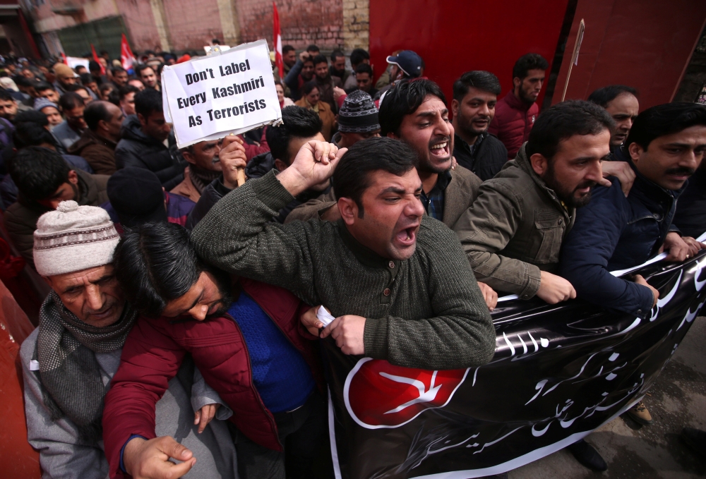 Activists of National Conference, one of the Kashmir's main pro-India political parties, shout slogans during a protest in Srinagar on Saturday against what the activists say is attacks on Kashmiris living outside their state. — Reuters