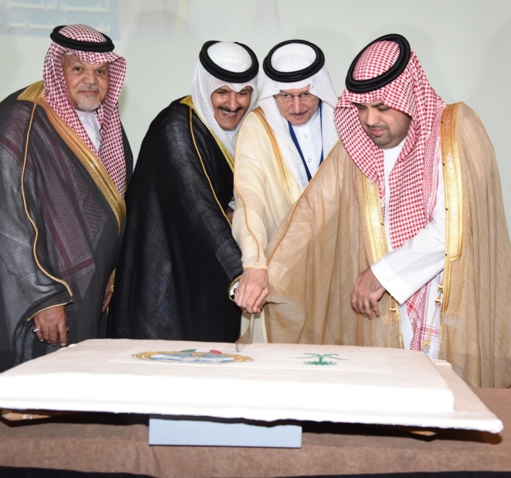 Wael Yousuf Enzi, consul general of Kuwait, along with Jamal Balkhoyour, director of the Foreign Ministry's Makkah region office, and OIC Secretary-General Dr. Yousef Al-Othaimeen cuts the celebratory cake.