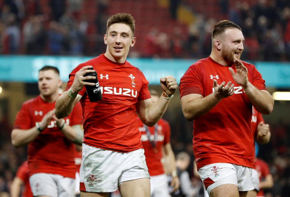 Wales' players celebrate victory over England in the Six Nations Championship match at Principality Stadium, Cardiff, Saturday. — Reuters