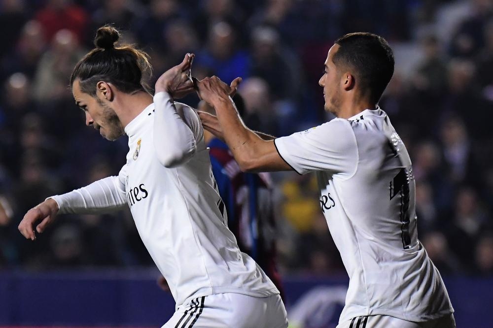 Gareth Bale (L) of Real Madrid celebrates with midfielder Lucas Vazquez after scoring a goal during the Spanish league football match against Levante at the Ciutat de Valencia Stadium in Valencia Sunday. — AFP 