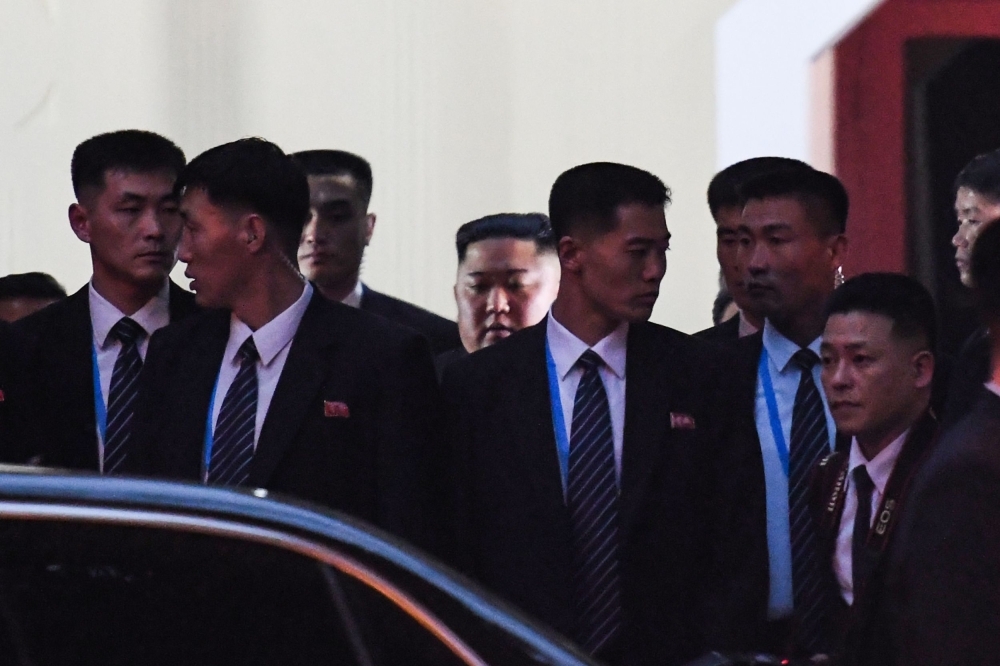 North Korean leader Kim Jong Un, center back, leaves after visiting the North Korean embassy in Hanoi on Tuesday, ahead of the second US-North Korean summit. — AFP