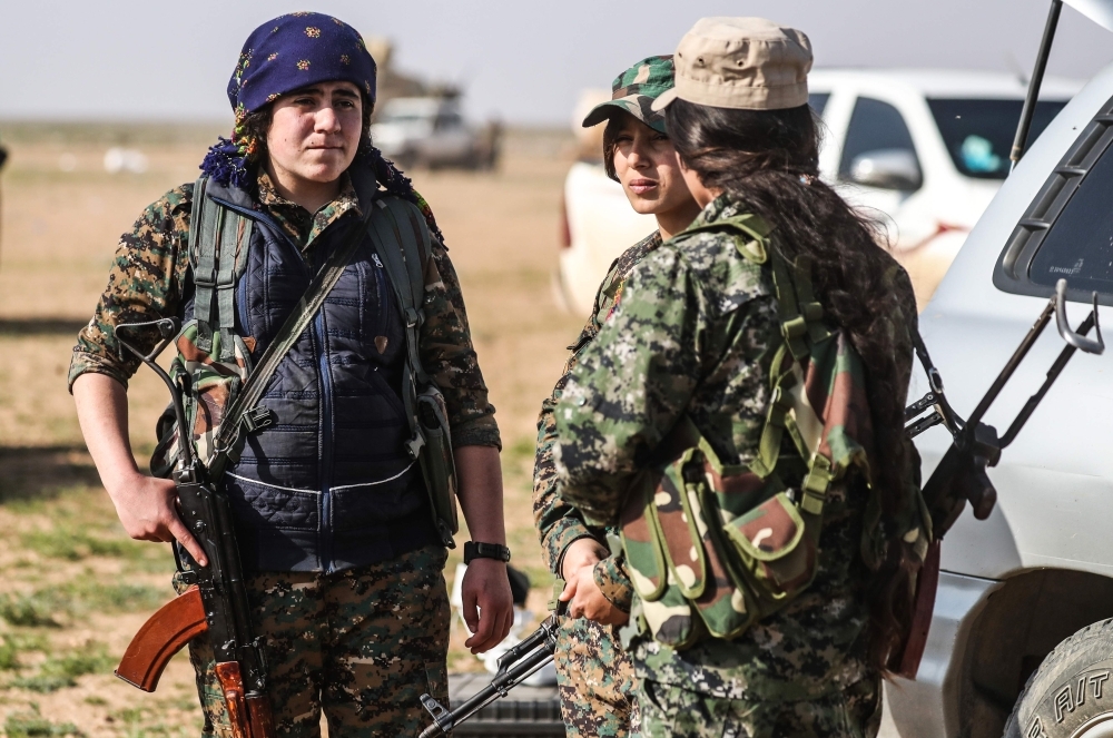 


Women and children evacuated from Daesh group’s embattled holdout of Baghouz wait in a zone held by the US-backed Syrian Democratic Forces (SDF) during an operation to expel Daesh militants from the area, in the eastern Syrian province of Deir Ezzor, Tuesday. — AFP photos