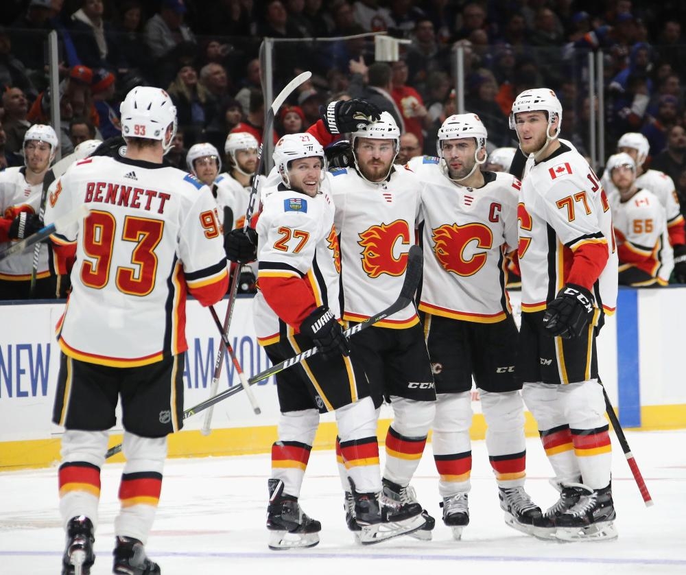 The Calgary Flames’ players celebrate their victory over the New York Islanders at NYCB Live’s Nassau Coliseum in Uniondale, New York, Tuesday. — AFP