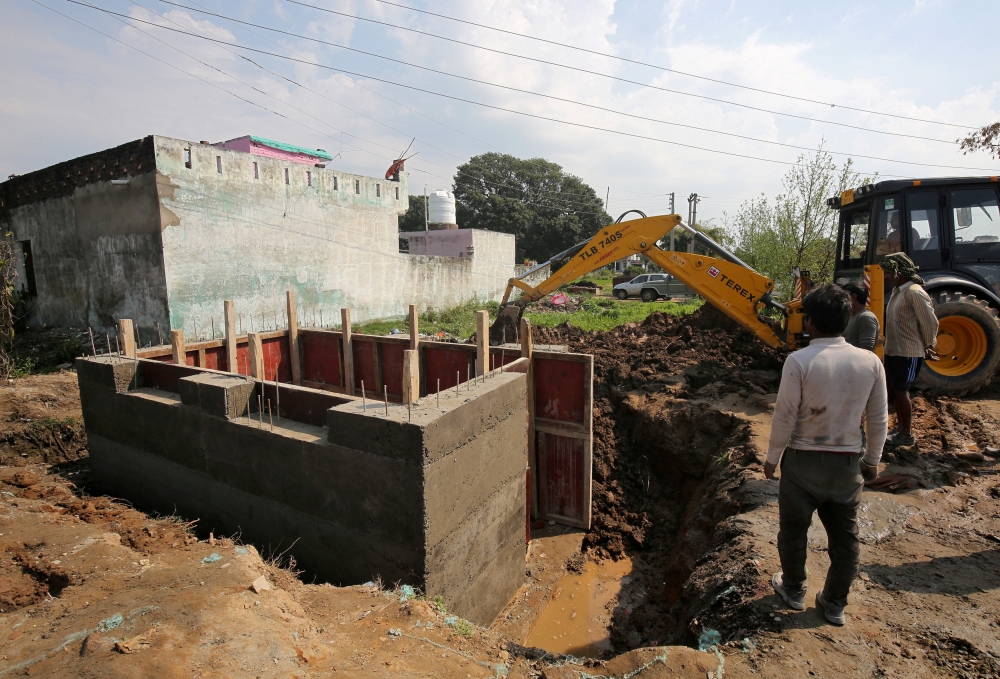 Workers construct a concrete bunker in a residential area near the border with Pakistan in Samba sector near Jammu, India, in this Feb. 26, 2019. — Reuters