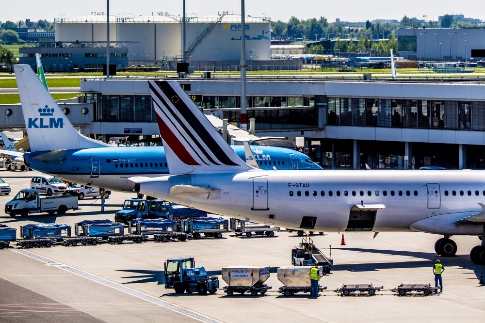 This file photograph shows Air France and KLM aircraft as they stand parked at Schiphol Airport, Netherlands. Economy Minister Bruno Le Maire on Thursday called on the Dutch government to 