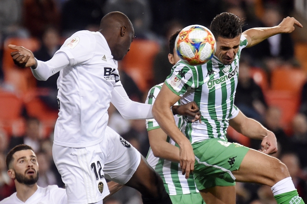 Valencia's French defender Mouctar Diakhaby (L) vies with Real Betis' Moroccan defender Zouhair Feddal during the Spanish Copa del Rey (King's Cup) semifinal second leg football match at the Mestalla stadium in Valencia on Thursday. — AFP