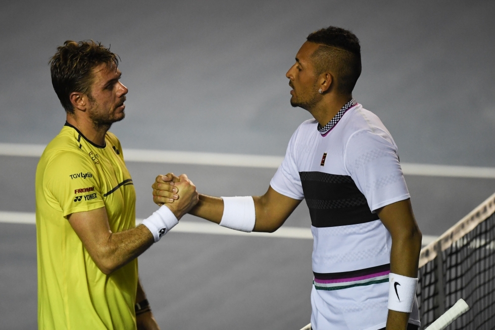 Australian tennis player Nick Kyrgios (R) shakes hands with Swiss tennis player Stan Wawrinka (L) after winning their Mexico ATP 500 Open men's single tennis match in Acapulco, Guerrero state, Mexico on Thursdasy. — AFP