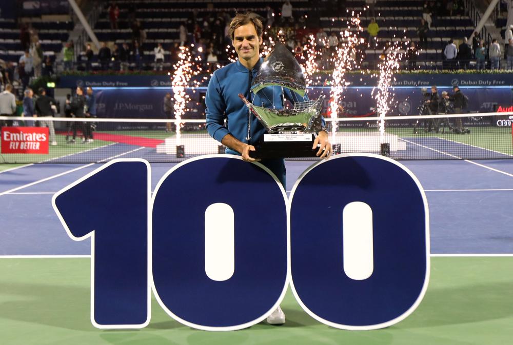 Switzerland's Roger Federer poses with the 100th trophy after beating Greece's Stefanos Tsitsipas at the Dubai Duty Free Tennis Championships Saturday. — Reuters