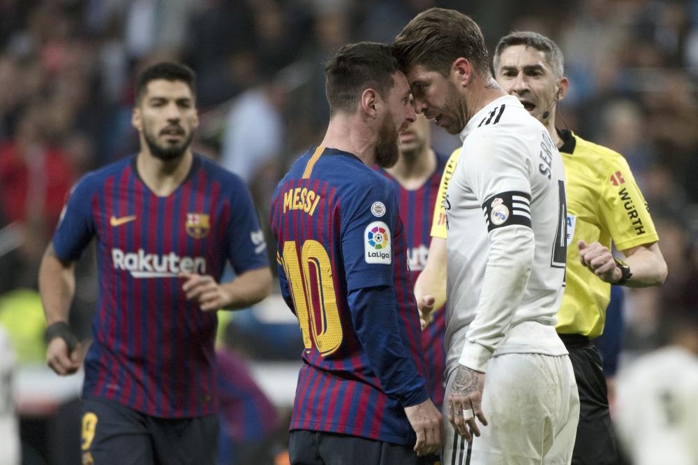 Barcelona’s Lionel Messi (2nd L) argues with Real Madrid’s Sergio Ramos during the Spanish league football match at the Santiago Bernabeu Stadium in Madrid Saturday. — AFP