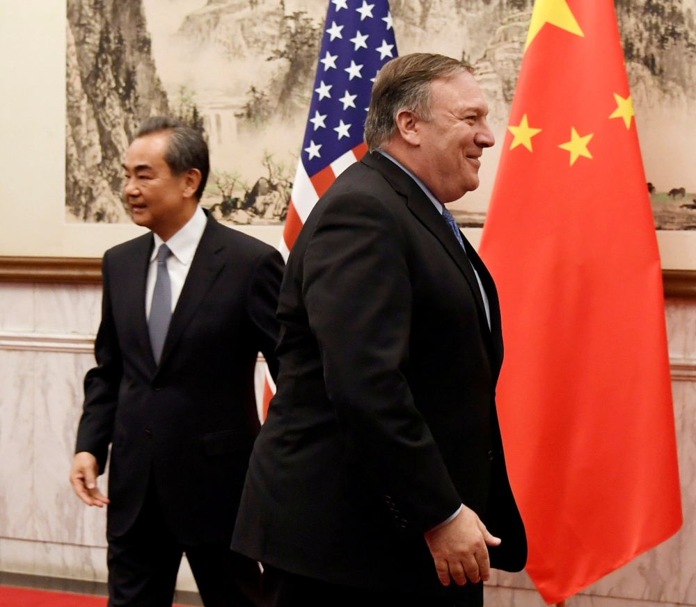 US Secretary of State Mike Pompeo is seen near Chinese State Councilor and Foreign Minister Wang Yi before a meeting at the Diaoyutai State Guesthouse in Beijing in this Oct. 8, 2018 file photo. — Reuters