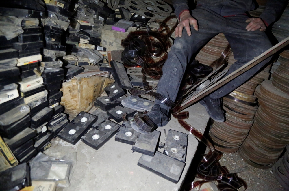 


A Palestinian worker checks materials in a former cinema in Tulkarm, in the Israeli-occupied West Bank. — Reuters photos