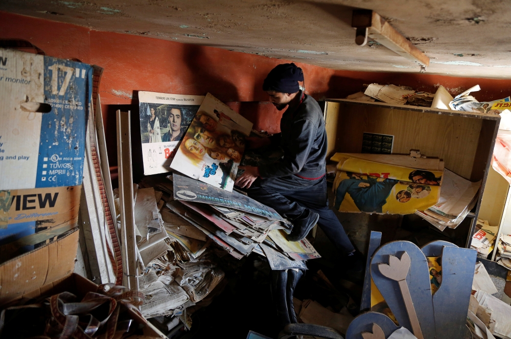 


A Palestinian worker checks materials in a former cinema in Tulkarm, in the Israeli-occupied West Bank. — Reuters photos