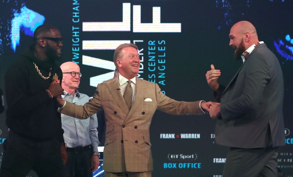 In this file photo WBC world heavyweight champion American Deontay Wilder (L), and former world heavyweight champion, British boxer Tyson Fury (R) are separated by boxing promoter and manager Frank Warren (C) during a press conference in London ahead of their scheduled title fight. — AFP