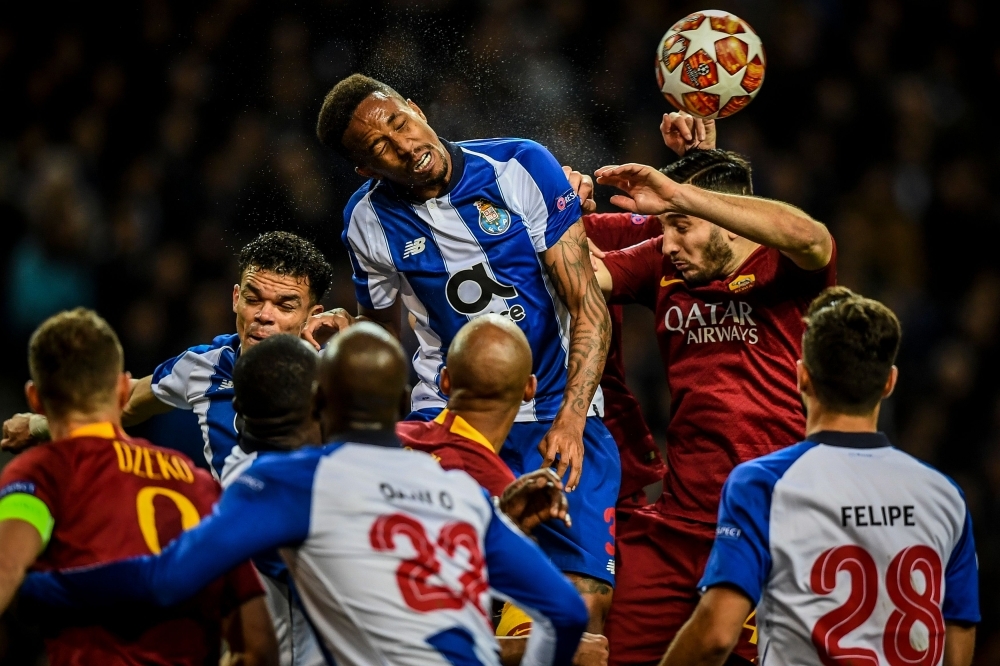 Porto's Brazilian defender Eder Militao (C) heads the ball with Roma's Czech forward Patrik Schick (R) during the UEFA Champions League round of 16 second leg football match between FC Porto and AS Roma at the Dragao stadium in Porto on Wednesday. — AFP