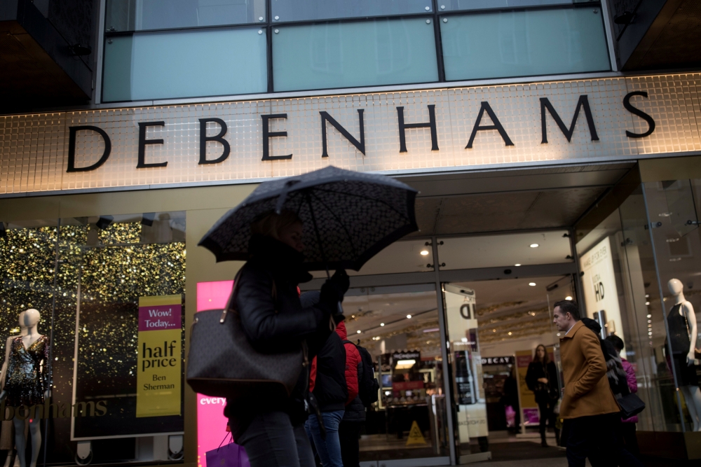 Shoppers walk past the Debenhams department store on Oxford Street in London, Britain in this file photo. — Reuters