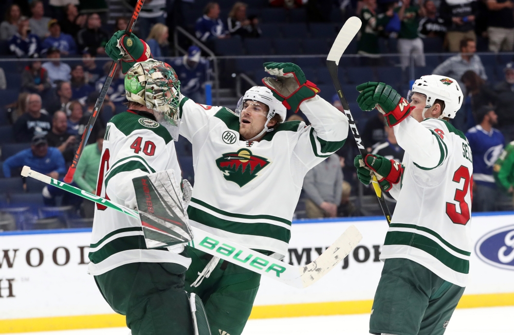 Minnesota Wild goaltender Devan Dubnyk (40) is congratulated by left wing Marcus Foligno (17) and defenseman Nick Seeler (36) as they beat the Tampa Bay Lightning at Amalie Arena. — Reuters