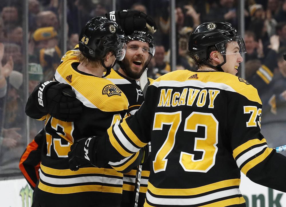 Boston Bruins’ David Krejci (C) is congratulated by Danton Heinen (L) and Charlie McAvoy (73) after scoring in the final minute of the third period of Boston’s 3-2 win over the Ottawa Senators at TD Garden in Boston Saturday. — Reuters