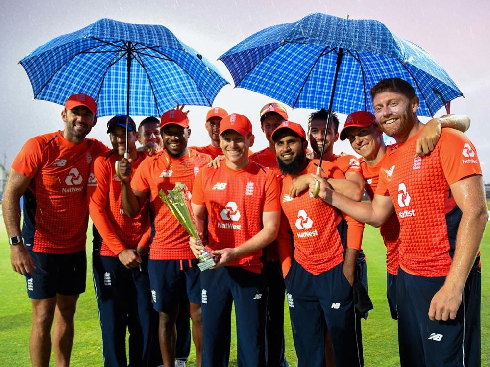 England players pose with the winning trophy at the end of the 3rd and final T20 International match against West Indies at Warner Park, Basseterre, Saint Kitts and Nevis, Sunday. — AFP