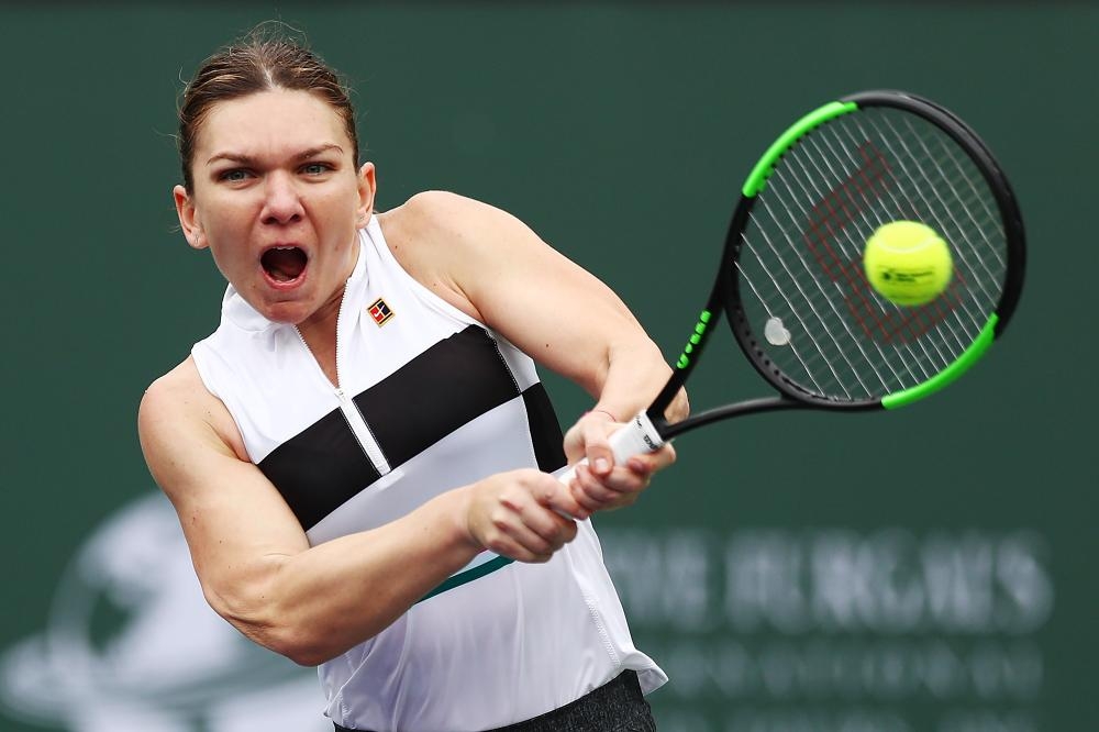 Simona Halep of Romania plays a forehand against Kateryna Kozlova of Ukraine at the BNP Paribas Open in Indian Wells Sunday. — AFP