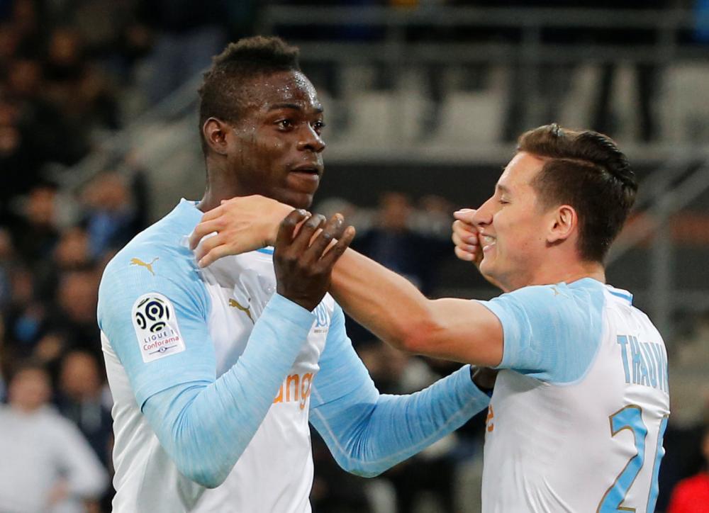 Marseille’s Mario Balotelli celebrates scoring their first goal with Florian Thauvin against Nice at Orange Velodrome, Marseille, Sunday. — Reuters