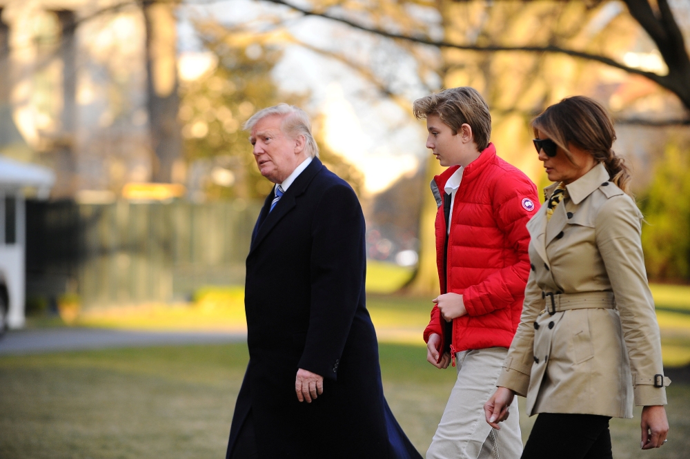 US President Donald Trump, First Lady Melania Trump and Barron Trump walk from Marine One as they return to the White House in Washington on Sunday. — Reuters