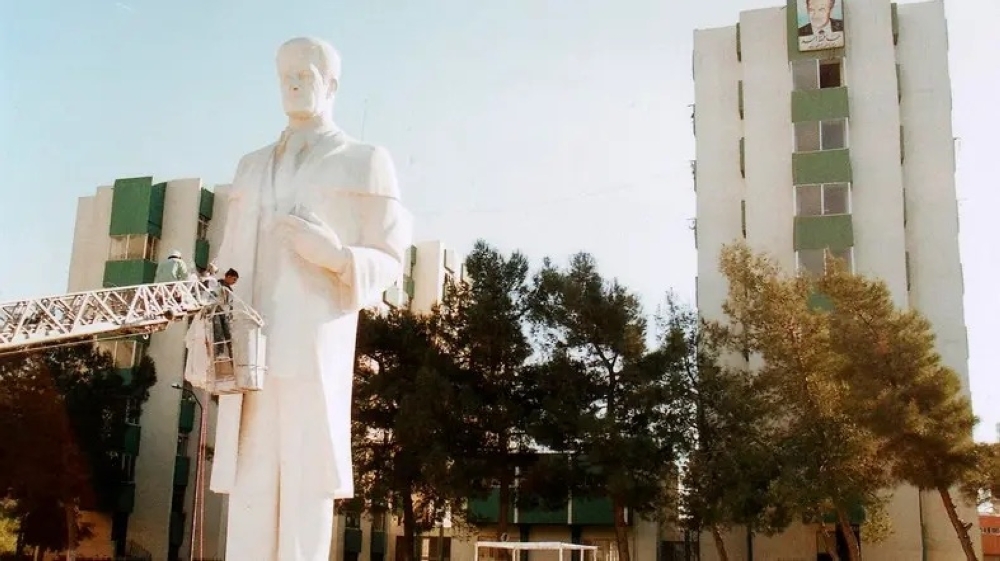 


A file photo showing workers installing a statue of Syria’s former president Hafez Al-Assad at the University of Damascus. — Courtesy photo