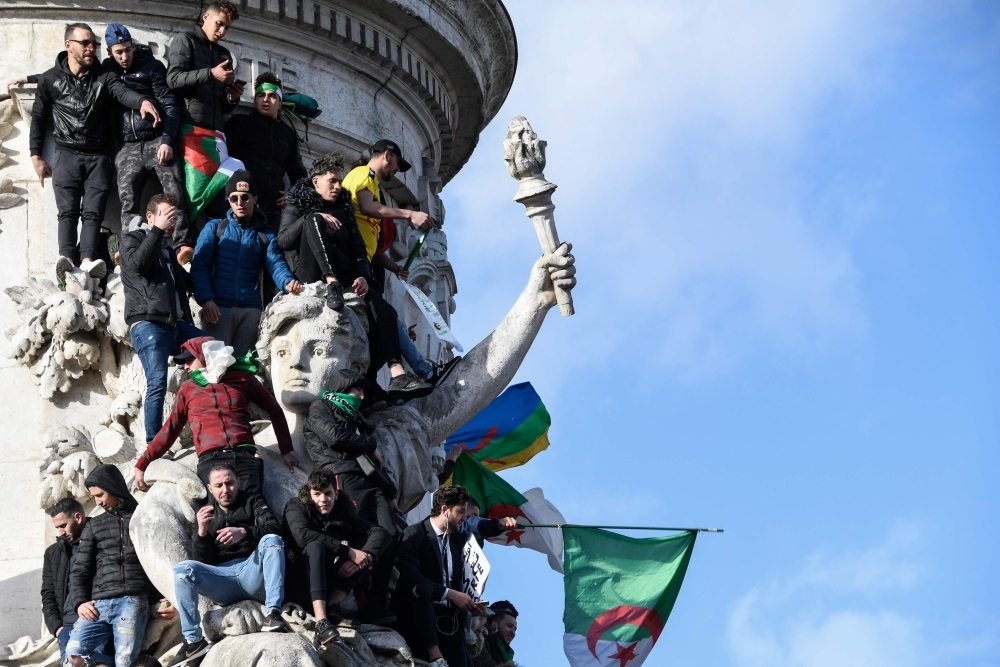 


People of Algerian origin take part in a rally in support of the ongoing protests in Algeria against the president’s bid for a fifth term in power, at Place de la Republique in Paris, Sunday. — AFP