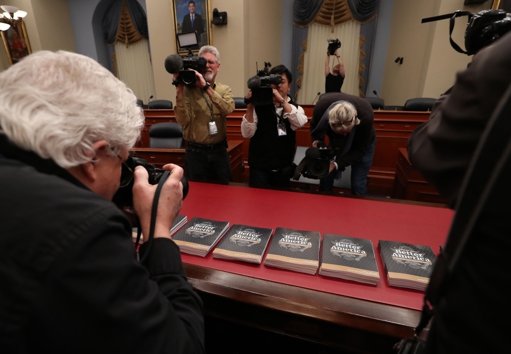 Members of the media gather around copies of volume 1 of President Donald Trumps new budget for Fiscal Year 2020 that has been delivered to the House Budget Committee in Washington on Monday. — AFP