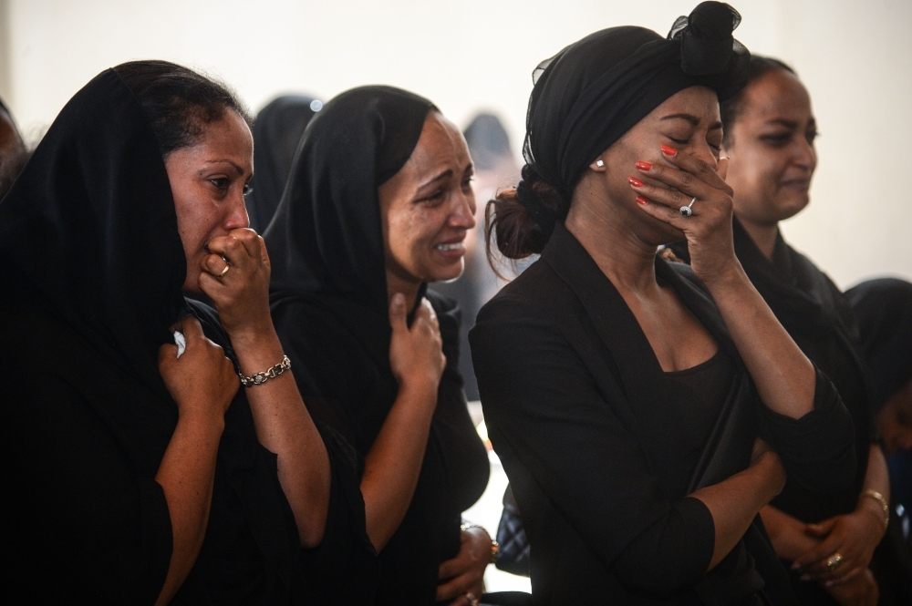 Women mourn during a memorial ceremony for the seven crew members who died in the Ethiopian Airlines accident at the Ethiopian Pilot Association Club in Addis Ababa, Ethiopia. — AFP