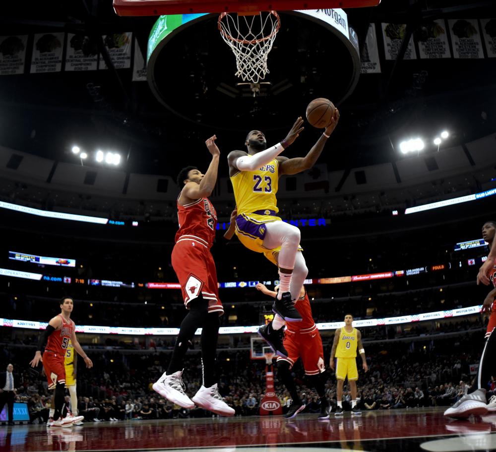 Los Angeles Lakers’ forward LeBron James goes for a basket against Chicago Bulls’ forward Otto Porter Jr. during their NBA game at the United Center in Chicago Tuesday. — Reuters 