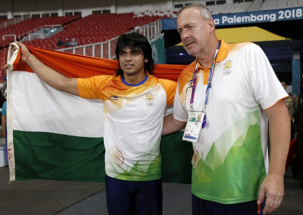Neeraj Chopra of India celebrates with his coach Uwe Hohn after winning gold medal in the 2018 Asian Games men's javelin throw event at the GBK Main Stadium, Jakarta, Indonesia, in this file photo. — Reuters