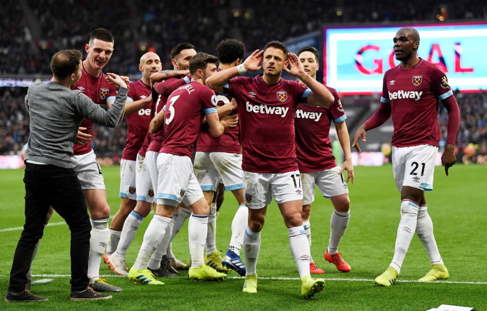 West Ham's Javier Hernandez celebrates scoring their fourth goal against Huddersfield during their Premier League match at London Stadium Saturday. — Reuters