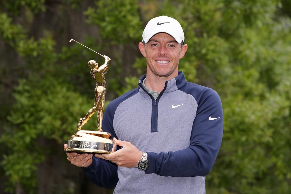 Rory McIlroy of Northern Ireland celebrates with the trophy after winning The Players Championship at TPC Sawgrass in Ponte Vedra Beach, Florida, Sunday. — AFP
