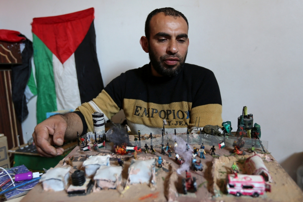 


Palestinian diorama artist Majdi Abu Taqeya works on miniature figures he carves from remnants of Israeli ammunition collected from the scenes of border protests along the Israel-Gaza border, in the central Gaza Strip. — Reuters photos