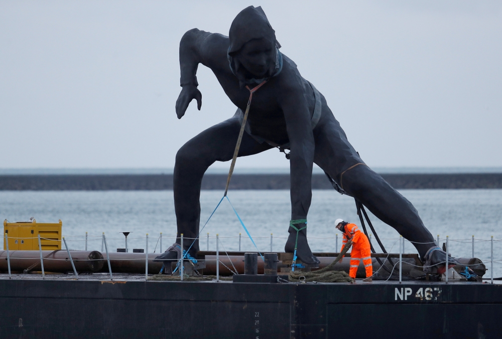 Britain's largest bronze sculpture arrives by barge in Plymouth Sound before being taken by road to the Theater Royal in Plymouth, Britain. — Reuters