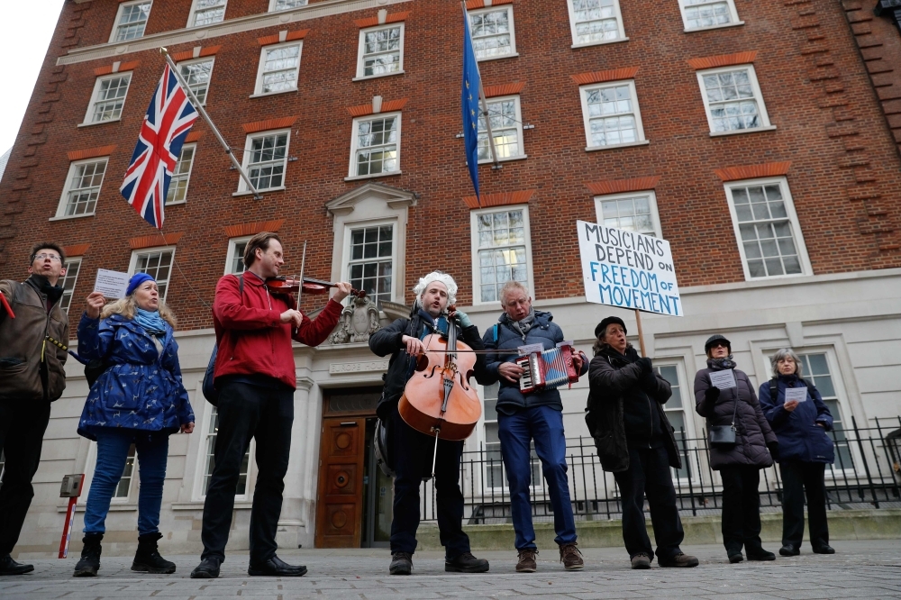 British-German musician Simon Wallfisch, center, poses playing the cello with supporters outside Europe House in Smith Square in London on Jan. 10, 2019 during a performance to protest Britain’s exit from the European Union (Brexit). — AFP