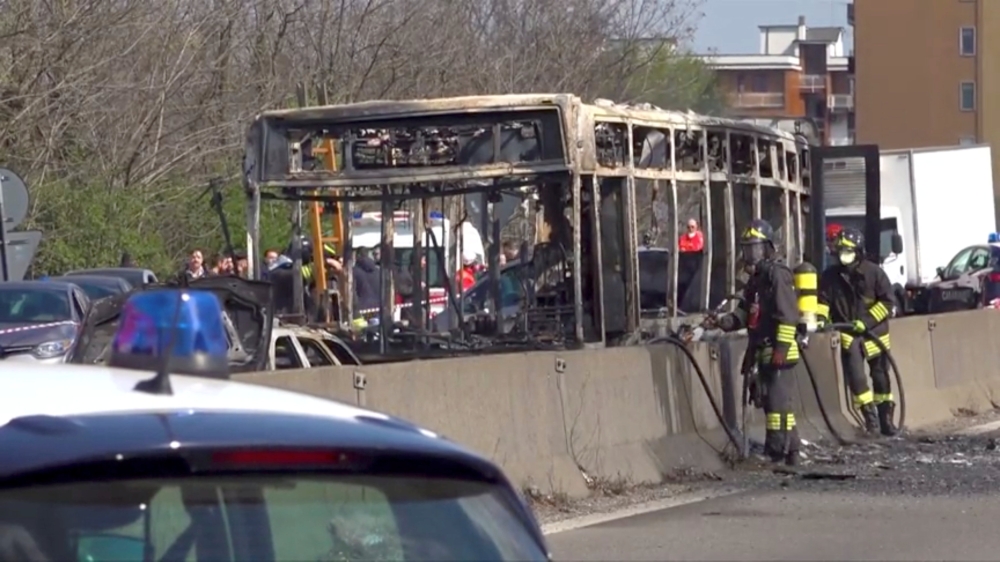 The wreckage of a bus that was set ablaze by its driver in protest against the treatment of migrants trying to cross the Mediterranean Sea, is seen on a road in Milan, Italy, on Wednesday. — Reuters