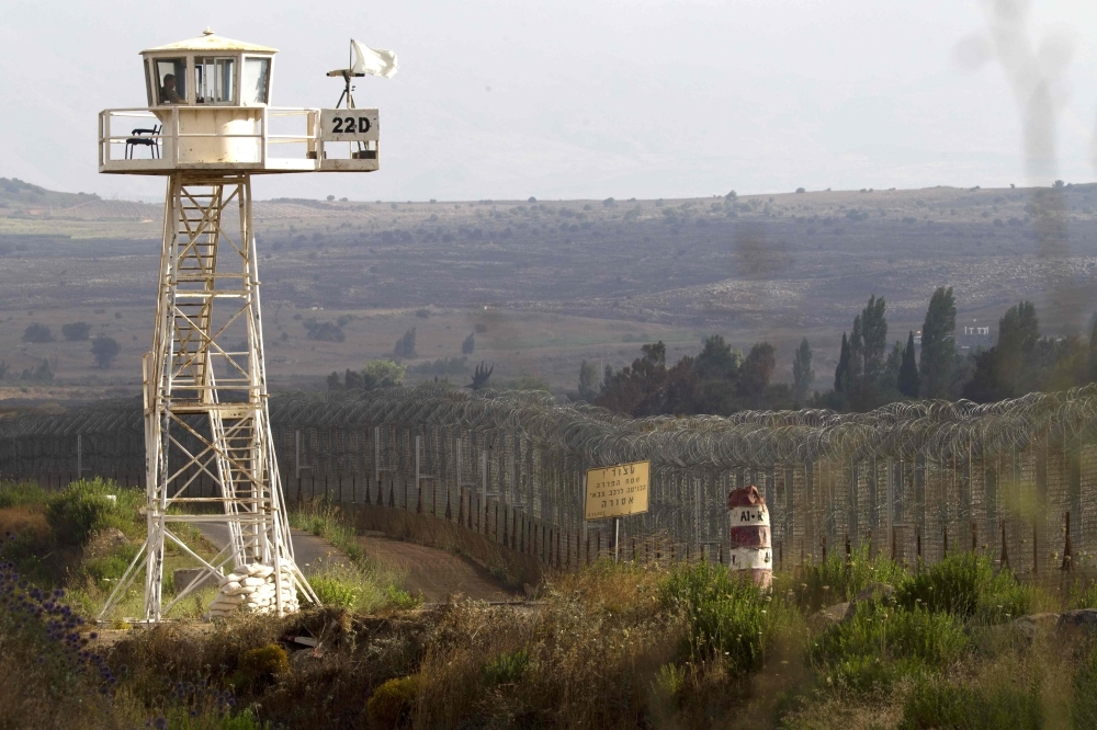 A file photo taken on the Israeli-occupied Golan Heights on July 18, 2013 shows a United Nations peacekeeper sitting in a watchtower near the Quneitra crossing in the demilitarized United Nations Disengagement Observer Force (UNDOF) zone. — AFP