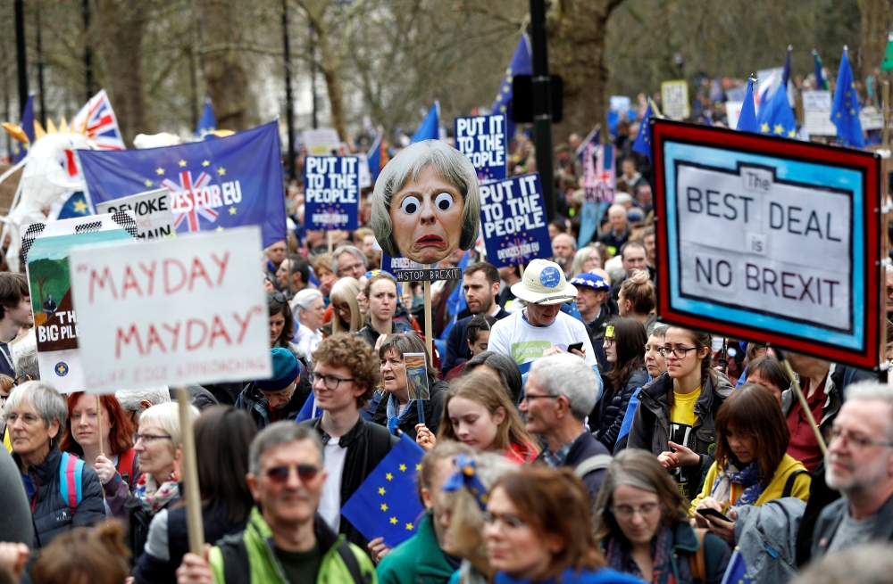 EU supporters, calling on the government to give Britons a vote on the final Brexit deal, participate in the 'People's Vote' march in central London, Saturday. — Reuters